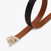 Monogram-spenne, vendbart skinnbelte